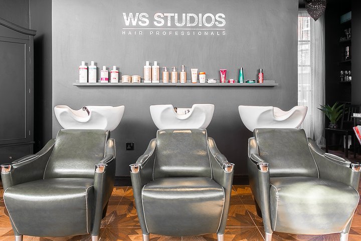Three wash chairs beneath the WS Studios sign